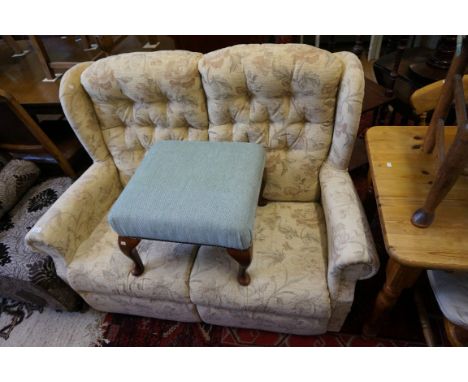 A modern button back two seater settee, bears relevant fire safety label, with modern upholstered foot stool raised on four c