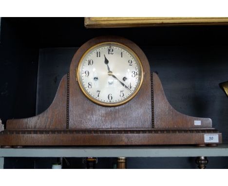 A large early 20th Century oak cased 'Admirals Hat' mantel clock, the good quality movement marked Junghans, Wurttemburg', an