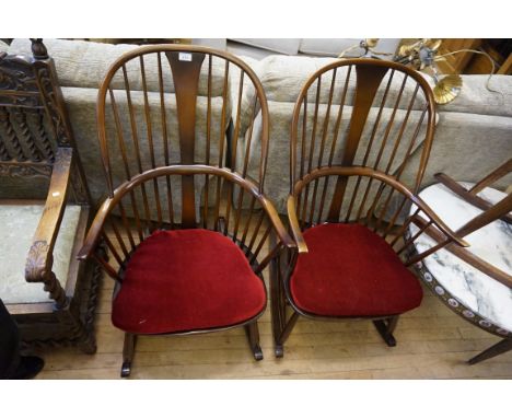 A pair of Ercol elm stick back Windsor rocking chairs.