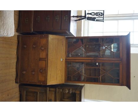 A 19th Century country oak bureau bookcase, the angled cornice above two astragal glazed doors enclosing fixed shelves, the h