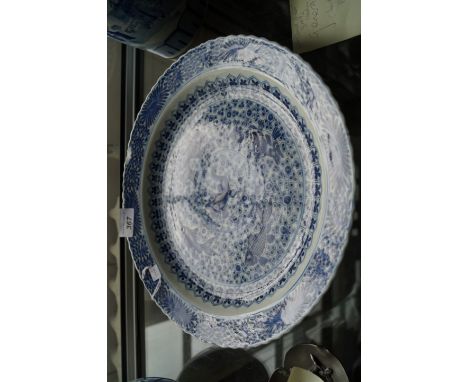 A Chinese blue and white porcelain dish,  Kangxi (1644-1722), of circular form, the exterior edge with a scalloped rim, the c