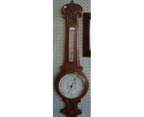 A late Victorian/Edwardian carved oak cased wheel barometer/thermometer, dial inscribed 'Admiral Fitzroy's Indications' and '