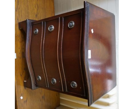 A reproduction Georgian style cross banded mahogany finished small chest of three drawers, with applied cast metal drop ring 