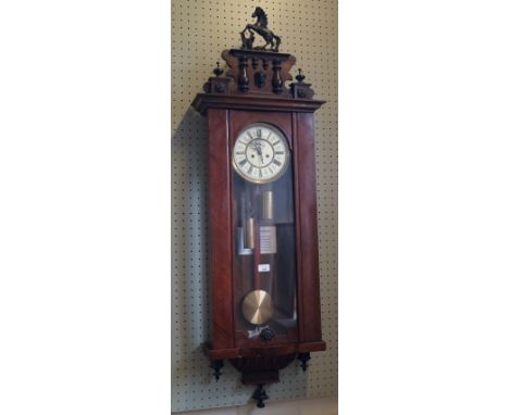A 19th century glazed mahogany stained Vienna-type wall clock, featuring an architectural pediment with rearing horse surmoun