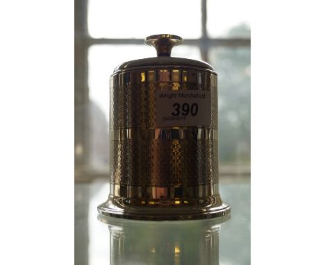 An Art Deco hallmarked silver cigarette dispenser with engine turned banded decoration.