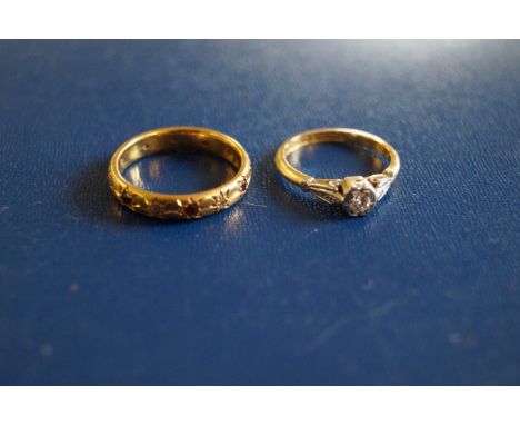 An 18ct gold ruby and diamond full hoop eternity ring, together with, a diamond solitaire ring with fancy shoulders to an 18c