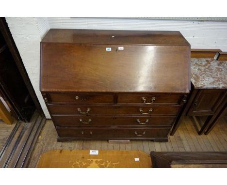 A George III boxwood strung mahogany bureau, the cross banded hinged sloping fall front enclosing a fitted interior, includin