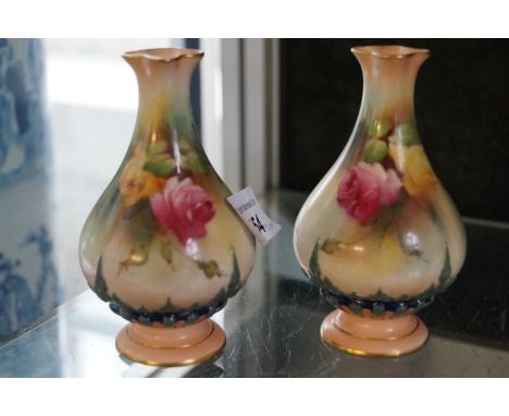 A pair of Royal Worcester baluster form vases, decorated with flowers and pinched rim (2) CONDITION REPORT:  Good overall con