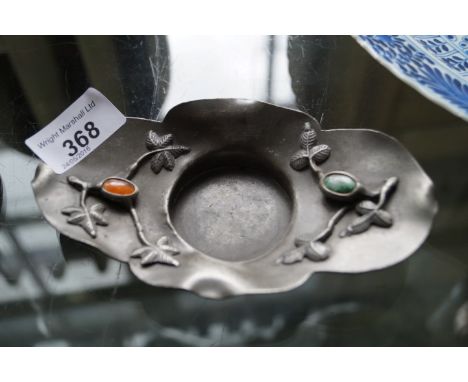 A Chinese pewter brush washer with faux Cornelian and jade inset roundels. 