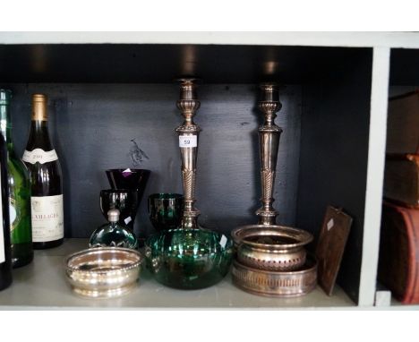 A pair of classical revival silver-plated candlesticks, three silver-plated coasters, a late 19th/early 20th Century embossed