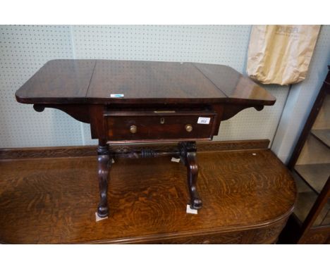 A Victorian rosewood drop leaf work table the rectangular top and drop leaves with rounded corners, above single frieze drawe