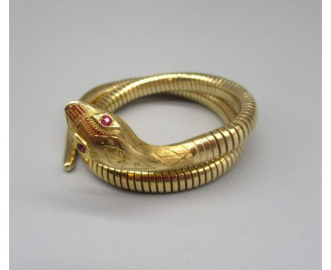 14ct yellow gold flexible snake bracelet, the head with engraved detail, set with ruby eyes, with flexible metal core, stampe