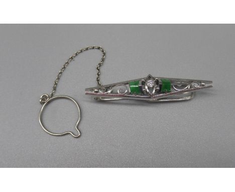 Platinum tie pin set with central diamond flanked by emeralds, stamped 850, 5.6g 
