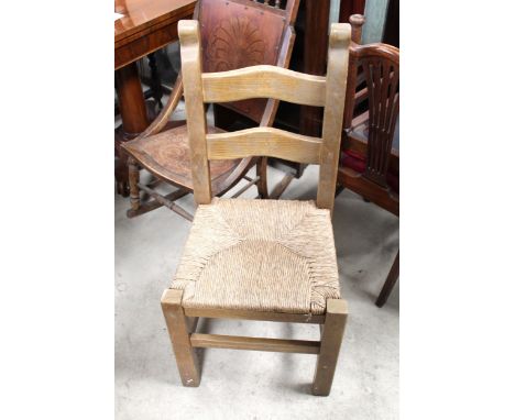 Set of twelve rush seat ladder back dining chairs and a pair of ladder back dining chairs with upholstered seats, (14) 