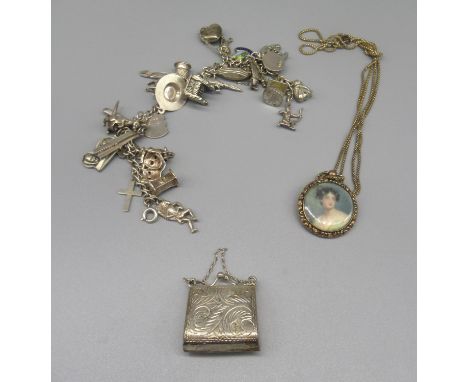 Sterling silver bracelet stamped Sterling, set with silver and white metal charms, a silver stamp holder in the form of a pur