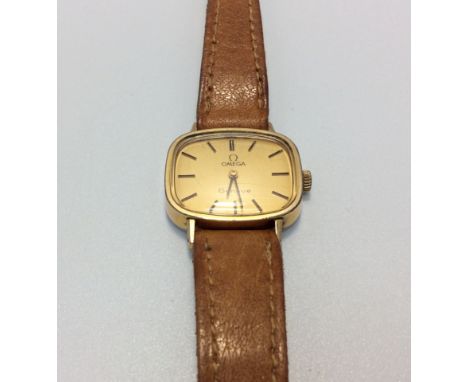 A ladies gold-plated Omega Geneve wristwatch, the gilt dial with batons denoting hours, on tan leather strap with branded buc