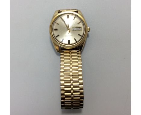 A gents gold-plated Omega Seamaster automatic wristwatch, the silvered dial with batons denoting hours and day-date aperture 