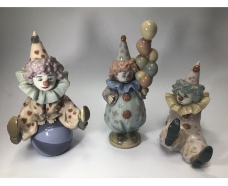 Three Lladro porcelain Clown / Pierrot figures including 'Littlest Clown', No.5811, 'Tired Friend', No.5812 and 'Having a Bal