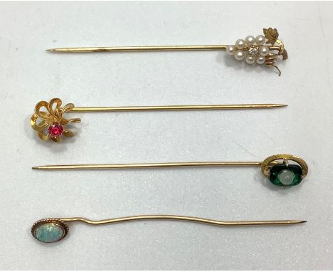 Four various gold stick / tie pins including a 14ct seed pearl modelled as a bunch of grapes with central small diamond, a 10