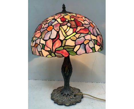 A reproduction Tiffany style table lamp with floral leaded glass shade and bronzed lilypad base, approx. 60cm high 