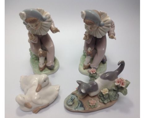 A Lladro porcelain figure 'Kitty Confrontation' No. 1442, together with a Nao duck figure group and two Nao figures of a seat