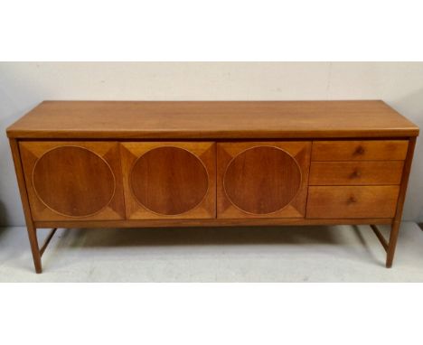 A mid-20th century Nathan Circles teak sideboard, with a pair of cupboard doors enclosing a narrow shelf, flanked either side