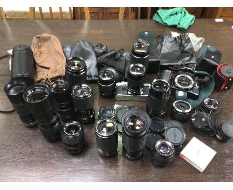 An Olympus OM10 camera with Super Travenar 1:2.8 lens, Canon EOS 100 carcass, various camera lenses including Vivitar 80-200m