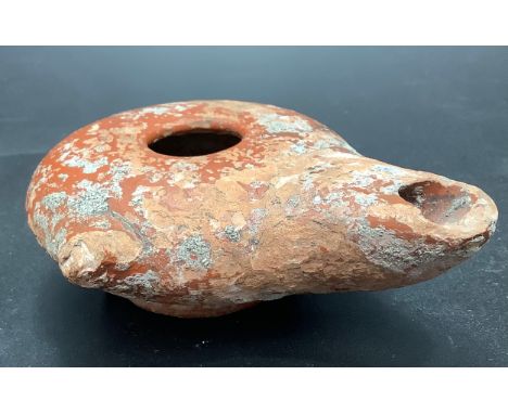 A Roman pottery oil lamp discovered on Hayling Island, 9cm diam 