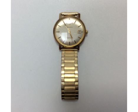 A gents 9ct gold cased Omega Seamaster De Ville, the silvered dial with applied gold batons denoting hours and date aperture 