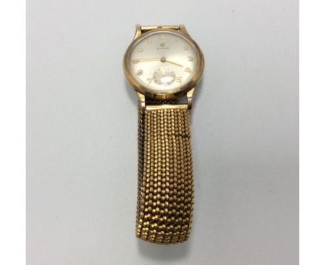A gents 9ct gold Cyma wristwatch, the silvered dial with Arabic numerals denoting hours and subsidiary seconds dial, on gold-