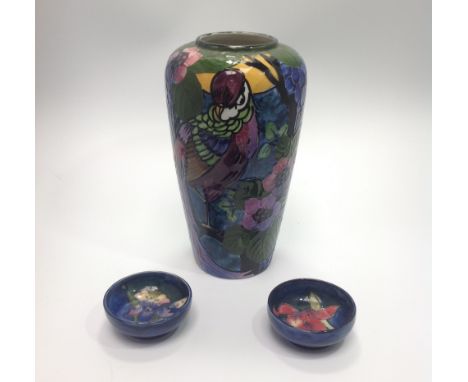 A 1920s Thomas Forester &amp; Son Trogon Ware vase, of tapering cylindrical form, decorated with a bird of paradise amongst f