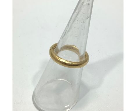 An 18ct yellow gold wedding band, weighing 5.1 grams, size J. 