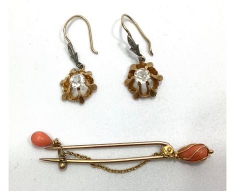 A yellow gold and coral brooch, sceptre style end with chain loop suspending a coral droplet, together with a pair of yellow 