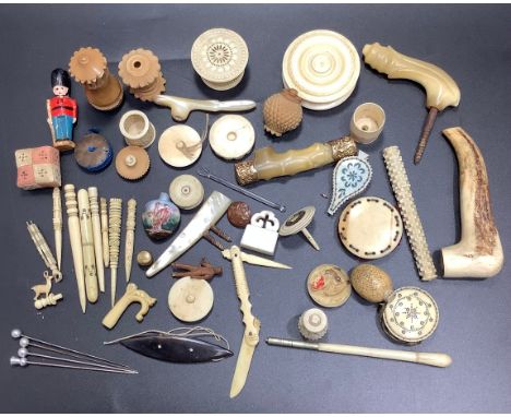 A quantity of Victorian ivory and bone sewing implements including two disc pin cushions, a pin cushion in the form of a pair