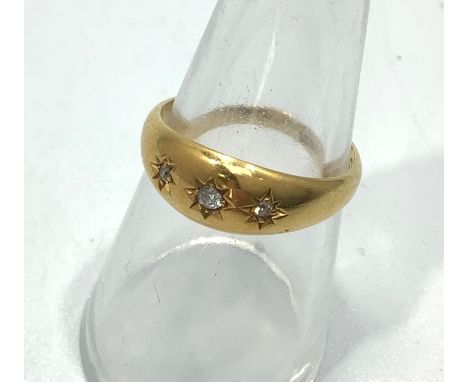 An 18ct yellow gold star set diamond dress ring, set with three small round brilliant cut diamonds, ring weighs 4.3 grams, si