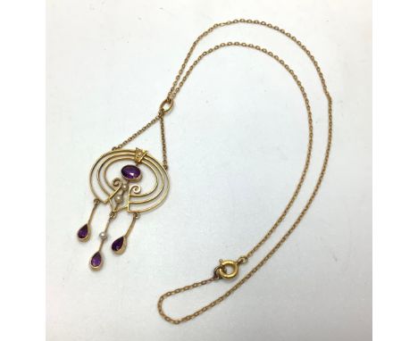 A yellow gold, amethyst and seed pearl necklace with three graduated circles, central amethyst above two seed pearls and thre