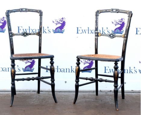 Pair of ebonised and mother of pearl inlaid chairs with caned seats       