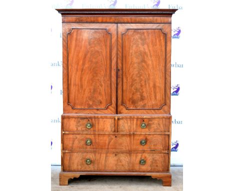 George III flame mahogany linen press with dentil cornice above panelled doors over two short over two long drawers on bracke