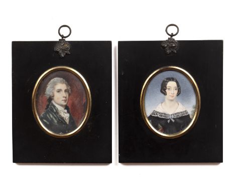 English School (19th century)A miniature oval portrait of a lady, with coiffed dark hair, black dress and lace trimmed white 