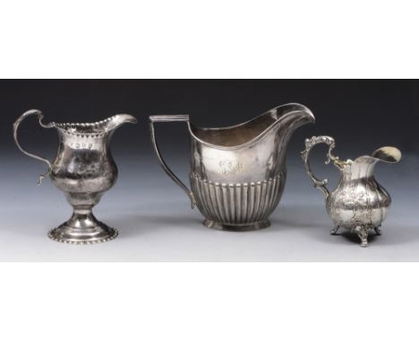 A GEORGE III SILVER HELMET JUG with punched decoration and double 'C' scroll handle, 11cm high, London 1772, makers mark obsc