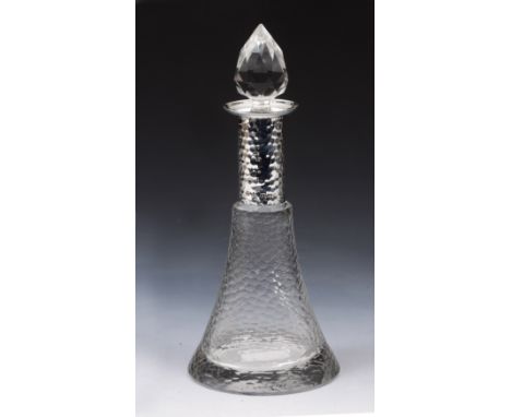 A SILVER MOUNTED DECANTER AND STOPPER of tapering form with textured finish and beaten silver mount, 22cm high, Birmingham 19