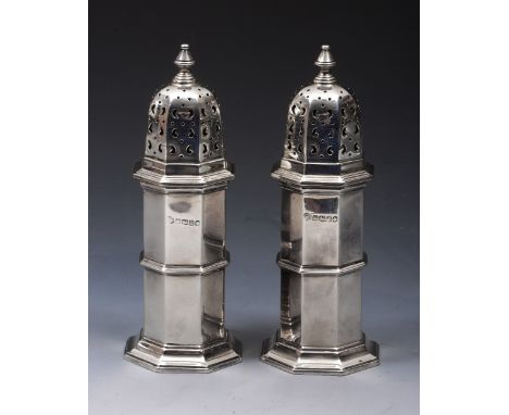 A PAIR OF SILVER CASTORS, octagonal lighthouse shaped with pierced press on lids and turned finials, 15cm high, Sheffield 193
