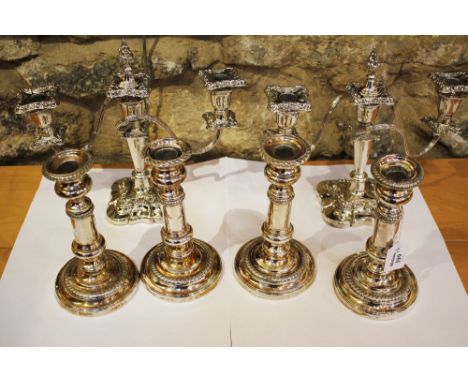 A SET OF FOUR ELECTROPLATED SILVER EXTENDING CANDLESTICKS with fluted decorated stepped bases and matching knops, 24cm high e