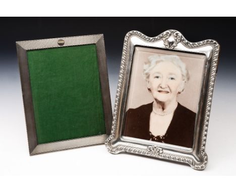 A RECTANGULAR SILVER PHOTO FRAME with engine turned decoration, 24cm high, London 1922 by Charles & Richard Comyns; and a fur