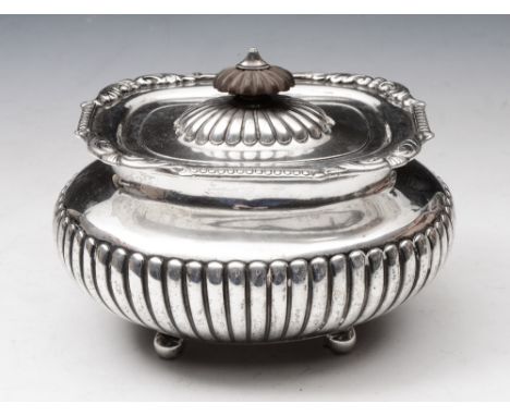 A LATE VICTORIAN SILVER TEA CADDY, oval shaped with wrythen lower body, matching hinged lid (detached) with scroll decoration