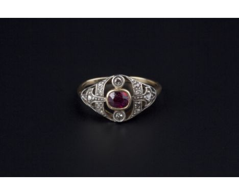 A RUBY AND DIAMOND PANEL RING, the oval mixed-cut ruby collet set within a pierced lozenge-shaped panel highlighted by single