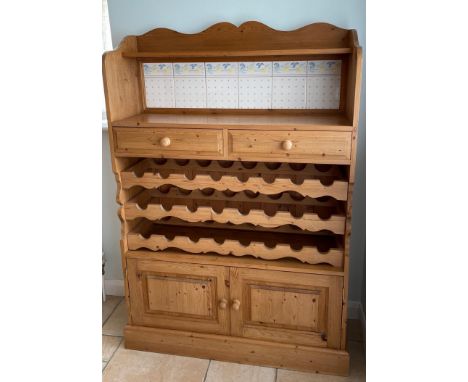 A pine tile inset kitchen cabinet with an in-built wine rack, 100 x 150cm. Condition: some tiles A/F.