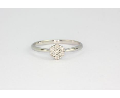 A 9ct white gold diamond set cluster ring, (P.5).