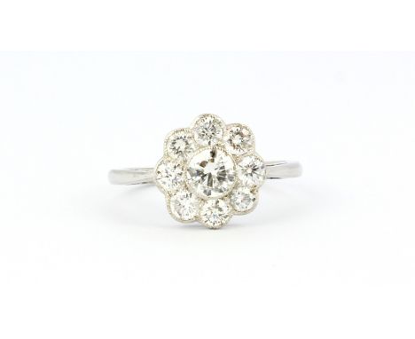 An 18ct white gold diamond set cluster ring, (P).