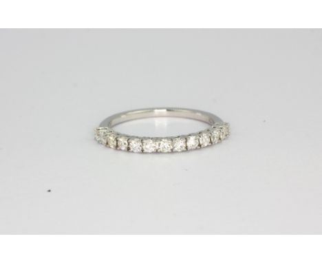 An 18ct white gold (750) diamond set half eternity ring, approx. 0.50ct, (N).